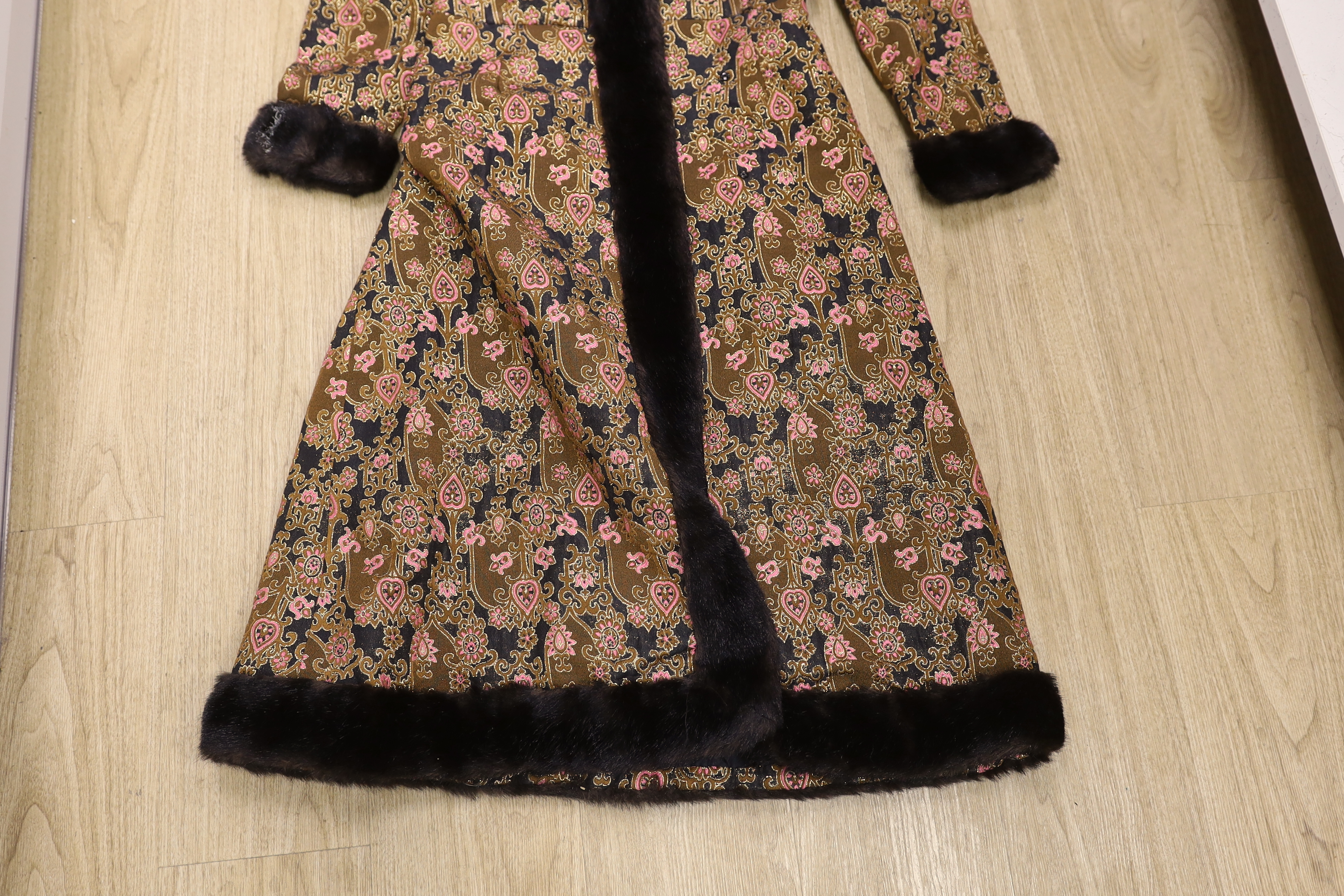 Two late 20th century brocade ladies evening coats, one with fur trimming to the neck, cuffs and bottom of coat